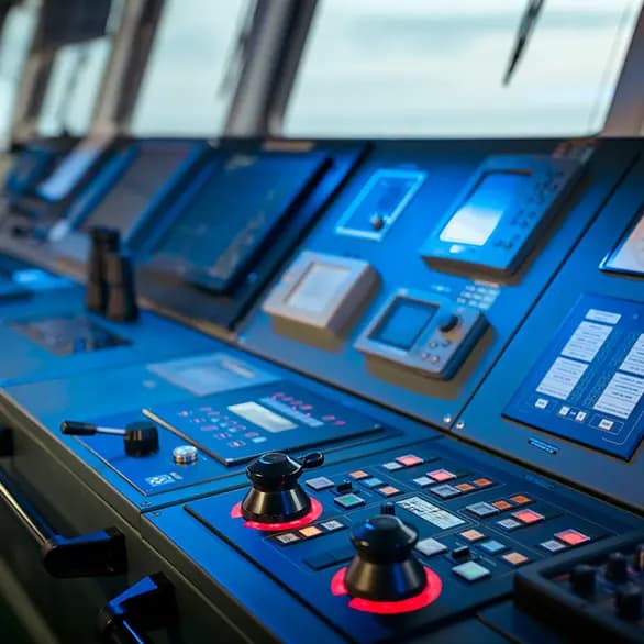 Modern ship bridge with Garmin marine displays and blue-lit controls